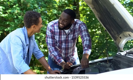 Black Father Explaining Car Structure To Son And Smiling, Teamwork, Family