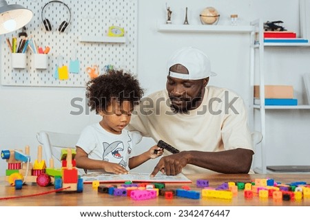 black father teaching his son how to read and watching his children play jigsaw puzzles to enhance learning skills with educational materials for kids. enhancing learning skills learning materials.