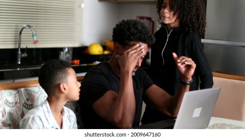 Black Father Working At Home While Children Interrupt And Complain