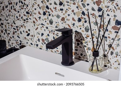 Black faucet on the washbasin in the bathroom, the wall is decorated with - Shutterstock ID 2093766505