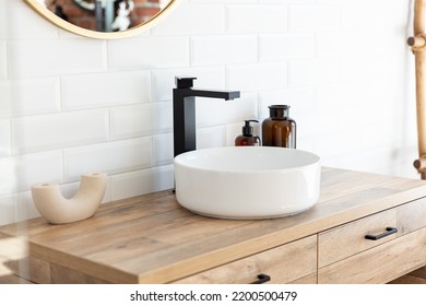 Black faucet for water and white separate high sink on wooden pedestal. Loft style bathroom. - Powered by Shutterstock