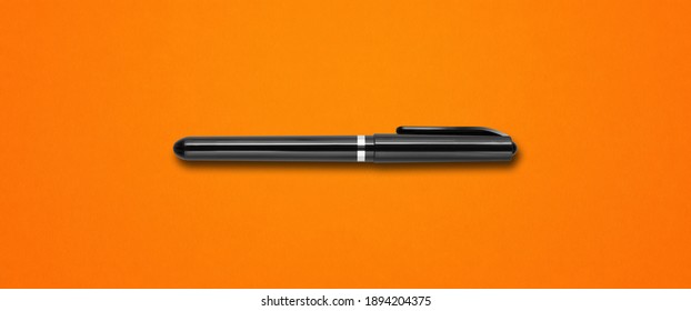 Black felt pen isolated on orange banner background