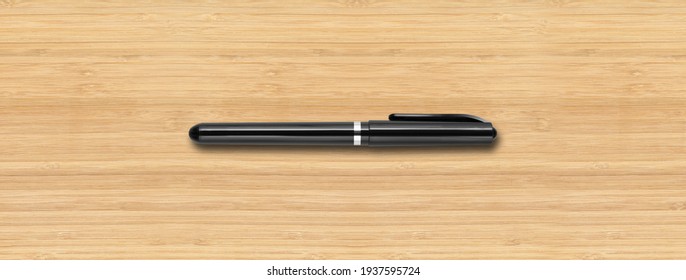 Black felt pen isolated on wooden banner background
