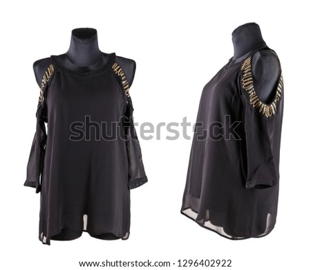 black female blouse or tunic with embroidery on the shoulders on the mannequin. isolated on white background
