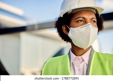 Black Female Building Contractor Wearing Face Mask And Construction Site During Coronavirus Epidemic