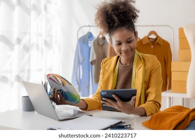 Black female designer, computer work, tailoring, fashion, small business Creative business African American entrepreneur girl smiles and checks online orders. Successful SME business idea. - Powered by Shutterstock