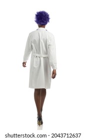 Black Female Doctor In High Heels And White Lab Coat Is Walking. Rear View. Full Length Studio Shot Isolated On White.