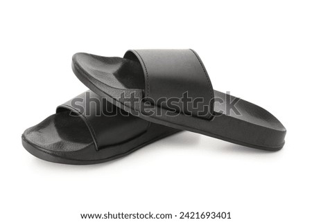 Black female flip flops on white background