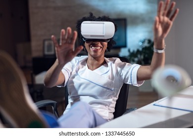 Black Female Healthcare Worker  Trying Out Virtual Reality Simulator While Taking A Break From Work. 