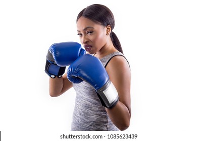 Black Female On A White Background Wearing Boxing Gloves Looking Confident And Smug.  Part Of Image Set For Gritty Woman Series.