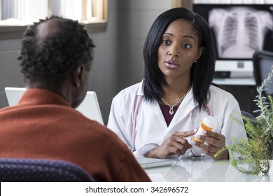 A black female physician prescribing pills to an older black male patient