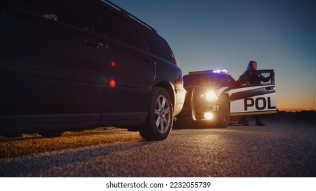 Black Female Police Officer Stepping Out of Patrol Car and Heading Towards a Pulled over Car. Cops Responding to a 911 Call About a Suspicious Car Stopped on the Road, Investigating the Situation - Shutterstock ID 2232055739