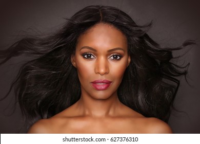 Black Female Portrait Fashion Beauty Model Studio Photograph With Hair Flowing. African American Woman With Long Hair And Beautiful Face.