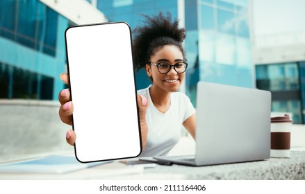 Black Female Student Demonstrating Big Blank Smartphone While Study Outdoors With Laptop, Smiling African American Female Recommending New Educational App Or Mobile Website, Collage, Mockup