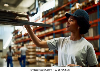 Black Female Warehouse Worker Inspecting Industrial Steel Products In A Storage Room. 