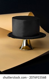 Black Festive Cake. Decor Trends. On The Gold And Blue Background.