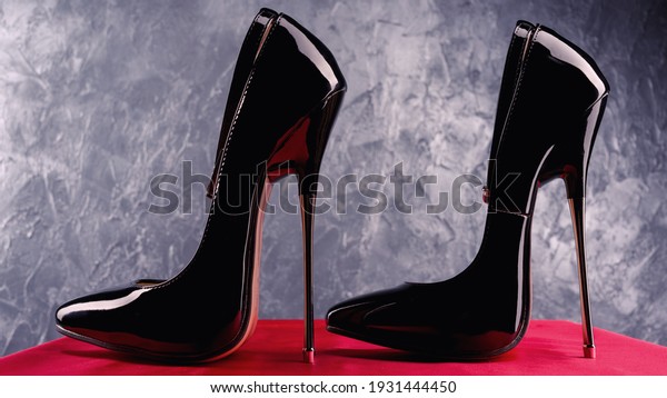 Black fetish shiny patent leather stiletto high\
heels with ankle strap
