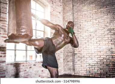 Black fighter training hard in his gym - Powered by Shutterstock