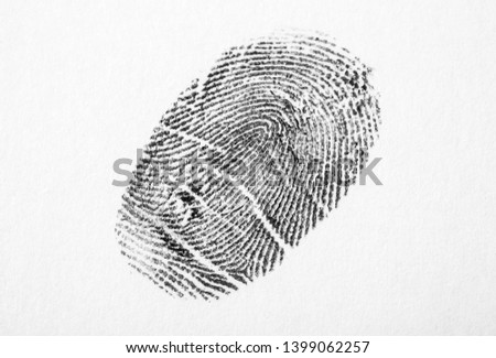 Black fingerprint on white background. Friction ridge pattern