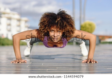 Similar – Young black woman doing stretching after running outdoors