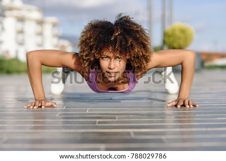 Similar – Young black woman doing stretching after running outdoors