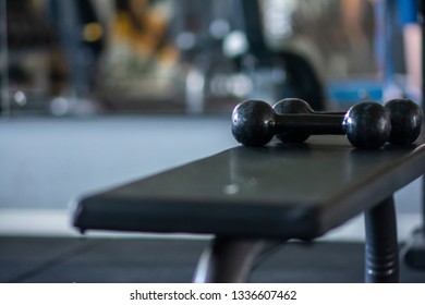 Black Fitness Dumbbells At The Gym Bench