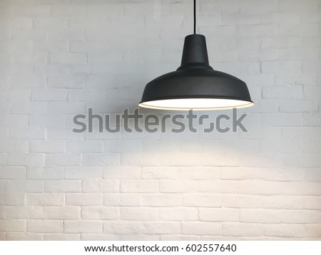 Black fixture and white brick wall.