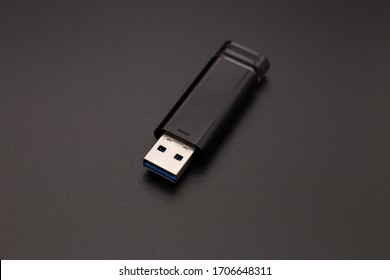 black flash drive on a dark background