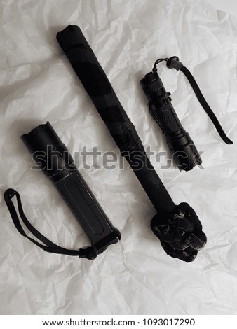 Black flashlight on torch of fire