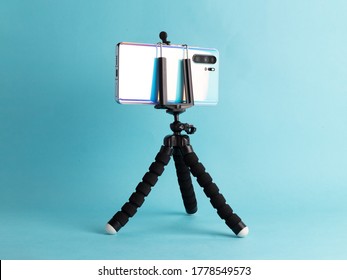 Black Flexible Tripod Holding A Cell Phone