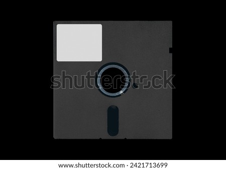 Black floppy disk or diskette isolated on black background