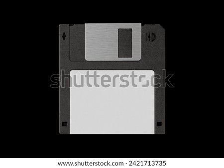 Black floppy disk or diskette isolated on black background