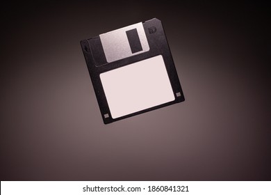 Black Floppy Diskette Levitating on Grey Background