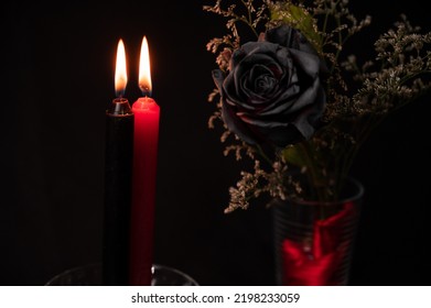 Black flower with black and red lit candle, Valentine's Day.
magic attributes, Wiccan rituals, esoteric concept, Spells,
wicca concept