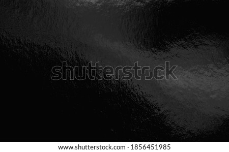 Black foil background with highlights and uneven texture