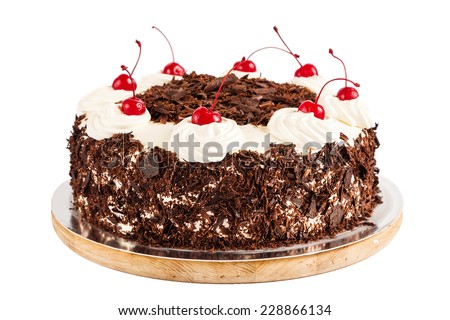 Black forest cake decorated with whipped cream and cherries. Isolated on white background