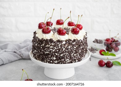 Black Forest Cake, Schwarzwald Pie. Cake With Dark Chocolate, Whipped Cream And Cherry On A Gray Concrete Background. Copy Space