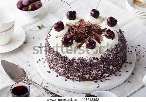 Black forest cake, Schwarzwald
pie, dark chocolate and cherry dessert on a white wooden
background.