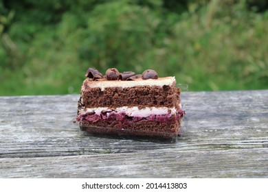 Black Forest Gateaux On A Bench With Blurred Background