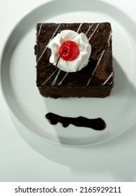 Black Forest Tart Chocolate Bread Wrapped In Chocolate Cream Is Usually Served For Birthdays, Valentines Or Other Party Events, Decorated With Cherries, Strawberries. Selective Focus