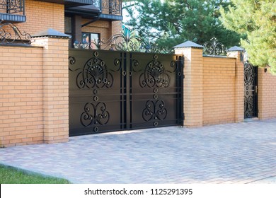 Black forged automatic gates in the cottage