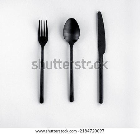 Black fork, spoon, knife isolated on white. Flat lay, top view. 