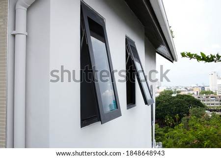 Black frame aluminium windows of building.
