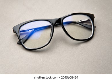 black frame blue light blocking technology anti glare spectacles glasses on grey background