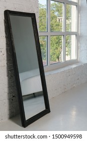 Black Frame Large Mirror Beside The Window