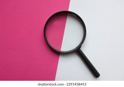 black frame a magnifying glass on Rectangle shape colored paper white and pink background - Powered by Shutterstock