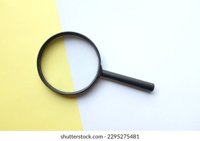 black frame a magnifying glass on rectangle shape colored paper white and yellow pastel background - Powered by Shutterstock