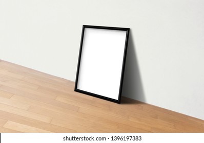 Black frame mockup against a white wall