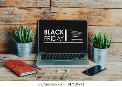 Black Friday Advertisement In A Laptop Computer Screen Placed On A Wooden Desk.