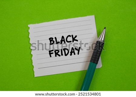 Black friday message written on ripped torn paper with a pen on green background. Conceptual black friday symbol. Copy space.